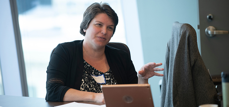 A woman in front of a laptop. Image is from the AHA History Gateways 2019 launch